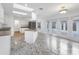 Modern kitchen with white cabinets, stone countertops, stainless steel appliances, and a view of the outdoor patio at 1773 South Dr, Sarasota, FL 34239