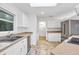 Bright kitchen with white cabinetry, stone countertops, stainless steel appliances, and a window view to the outdoors at 1773 South Dr, Sarasota, FL 34239