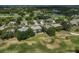 Aerial shot showing a home in a golf community with well-manicured greens and tree-lined streets at 2111 Muskogee Trl, Nokomis, FL 34275
