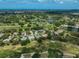 Expansive aerial view of the community with lush landscaping, serene lakes, and a picturesque golf course at 2111 Muskogee Trl, Nokomis, FL 34275