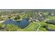 Picturesque aerial showcasing community amenities, including a golf course, lake, and clubhouse at 2111 Muskogee Trl, Nokomis, FL 34275