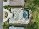 Overhead aerial of home with a screened-in pool, lush landscaping, and circular driveway at 2111 Muskogee Trl, Nokomis, FL 34275