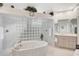Neutral toned bathroom featuring tub, walk-in shower, and vanity at 2111 Muskogee Trl, Nokomis, FL 34275