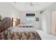 Bright bedroom featuring twin beds with floral bedding, ceiling fan, and a closet at 2111 Muskogee Trl, Nokomis, FL 34275