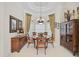 Elegant dining room featuring large windows, a tray ceiling, and a decorative chandelier at 2111 Muskogee Trl, Nokomis, FL 34275