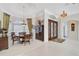 Bright dining room featuring a tray ceiling, large windows, and an elegant chandelier at 2111 Muskogee Trl, Nokomis, FL 34275