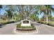 Elegant community entrance with lush landscaping and a welcoming sign, creating a strong sense of arrival at 2111 Muskogee Trl, Nokomis, FL 34275
