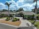 Attractive single-story home with circular brick driveway, mature landscaping, and tile roof at 2111 Muskogee Trl, Nokomis, FL 34275