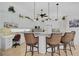 Bright kitchen features white cabinets, an island with bar seating, and pendant lighting at 2111 Muskogee Trl, Nokomis, FL 34275