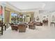 Spacious living room with large windows overlooking the pool and an open floor plan at 2111 Muskogee Trl, Nokomis, FL 34275