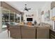 Spacious living room with large windows overlooking the pool and a comfortable sectional sofa at 2111 Muskogee Trl, Nokomis, FL 34275