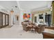 Spacious living room featuring tile floors, large windows, and a view of the backyard pool at 2111 Muskogee Trl, Nokomis, FL 34275