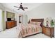 Spacious main bedroom with ceiling fan, carpet flooring and ensuite at 2111 Muskogee Trl, Nokomis, FL 34275