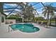Screened-in pool and spa offer a private outdoor oasis with serene landscaping at 2111 Muskogee Trl, Nokomis, FL 34275