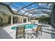 Relax by the screened-in pool, which is surrounded by ample seating at 2111 Muskogee Trl, Nokomis, FL 34275