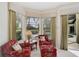 Cozy sitting area with outdoor view and two chairs with matching ottoman at 2111 Muskogee Trl, Nokomis, FL 34275
