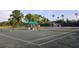 Well-maintained tennis courts with a shaded rest area, perfect for recreational play and community engagement at 2111 Muskogee Trl, Nokomis, FL 34275
