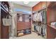 Organized walk-in closet featuring custom shelving and hanging rods at 2111 Muskogee Trl, Nokomis, FL 34275