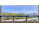 Balcony view from a building that overlooks a lagoon, trees, and blue skies above at 2120 Harbourside Dr # 621, Longboat Key, FL 34228