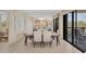 Elegant dining room with a modern table setting, neutral décor, and sliding glass doors to the balcony at 2120 Harbourside Dr # 621, Longboat Key, FL 34228