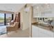 Open-concept living space with a view of the balcony, the dining room and a butlers pantry at 2120 Harbourside Dr # 621, Longboat Key, FL 34228