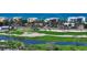Aerial view showcasing the condo building's proximity to a golf course and other local buildings at 2185 Gulf Of Mexico Dr # 243, Longboat Key, FL 34228