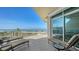 Expansive balcony with lounge chairs offering stunning views of the beach and ocean at 2185 Gulf Of Mexico Dr # 243, Longboat Key, FL 34228