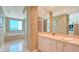 Bathroom featuring a bathtub with ocean views and a large vanity with ample lighting at 2185 Gulf Of Mexico Dr # 243, Longboat Key, FL 34228