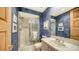 Updated bathroom showcasing blue wallpaper, a shower and plenty of counter space at 2185 Gulf Of Mexico Dr # 243, Longboat Key, FL 34228