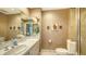 Well-lit bathroom with white tile, stylish fixtures, and a walk-in shower at 2185 Gulf Of Mexico Dr # 243, Longboat Key, FL 34228