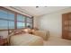 Comfortable bedroom featuring two twin beds, plantation shutters and an ample closet at 2185 Gulf Of Mexico Dr # 243, Longboat Key, FL 34228