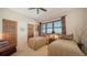 Cozy bedroom with two twin beds, plantation shutters, and warm, inviting decor at 2185 Gulf Of Mexico Dr # 243, Longboat Key, FL 34228