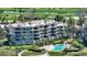 Multi-story condominium features beautiful landscaping, a pool, and golf course views at 2185 Gulf Of Mexico Dr # 243, Longboat Key, FL 34228
