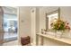 Inviting entryway featuring a marble-topped console table with flowers and a view into the living room at 2185 Gulf Of Mexico Dr # 243, Longboat Key, FL 34228
