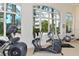 Bright home gym with large windows overlooking palm trees and exercise equipment at 2185 Gulf Of Mexico Dr # 243, Longboat Key, FL 34228
