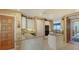 Open kitchen featuring granite countertops, white cabinets, and views of the dining and living areas at 2185 Gulf Of Mexico Dr # 243, Longboat Key, FL 34228