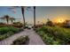 Scenic walkway amidst colorful landscaping leads to stunning sunsets over the ocean at 2185 Gulf Of Mexico Dr # 243, Longboat Key, FL 34228