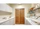 Functional laundry room featuring a sink, storage cabinets, washer, and dryer at 2185 Gulf Of Mexico Dr # 243, Longboat Key, FL 34228