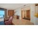 Bright living room with tile floors, a built-in wooden cabinet, and ocean views from the balcony at 2185 Gulf Of Mexico Dr # 243, Longboat Key, FL 34228