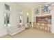 Bright and airy living room features a cozy sofa, breakfast bar, and sun-filled windows showcasing lush greenery at 2185 Gulf Of Mexico Dr # 243, Longboat Key, FL 34228