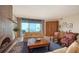 Bright living room featuring a stone fireplace, ocean views, and traditional furnishings at 2185 Gulf Of Mexico Dr # 243, Longboat Key, FL 34228