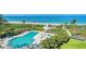 Resort-style pool and hot tub with lush landscaping offer a relaxing oasis by the beach at 2185 Gulf Of Mexico Dr # 243, Longboat Key, FL 34228