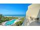 A stunning view of the pool and surrounding beach from the balcony at 2185 Gulf Of Mexico Dr # 243, Longboat Key, FL 34228