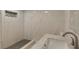 The bathroom features marble-look tile, a shower and dark gray accent tiles at 2319 Beneva Ter # 2284, Sarasota, FL 34232