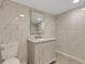 Bathroom with marble-look tile, a gray vanity, and a stylish framed mirror at 2319 Beneva Ter # 2284, Sarasota, FL 34232