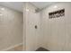 Bathroom featuring a glass-enclosed shower, marble-look tile, and a gray accent at 2319 Beneva Ter # 2284, Sarasota, FL 34232