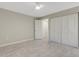 A spacious bedroom featuring tile flooring, closet doors, and a ceiling fan at 2319 Beneva Ter # 2284, Sarasota, FL 34232