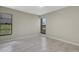 A sunlit bedroom featuring tile flooring and large windows offering exterior views at 2319 Beneva Ter # 2284, Sarasota, FL 34232