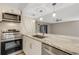 Modern kitchen featuring stainless steel appliances, a peninsula counter with sink, and stylish backsplash at 2319 Beneva Ter # 2284, Sarasota, FL 34232