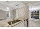 Modern kitchen with granite countertop, stainless steel sink, pendant lighting, and an open layout at 2319 Beneva Ter # 2284, Sarasota, FL 34232